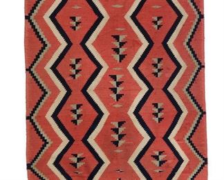 97
A Navajo Child's Blanket
Early 20th Century
With columns of conjoined diamonds woven in raveled red American flannel, indigo blue, cream, and light green
49" L x 30.5" W
Estimate: $1,000 - $1,500