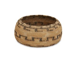 117
A Poma Gift Basket
First-quarter 20th Century
Woven with hooked rim, stepped band, and Z motif
2.75" H x 6" Dia.
Estimate: $400 - $600