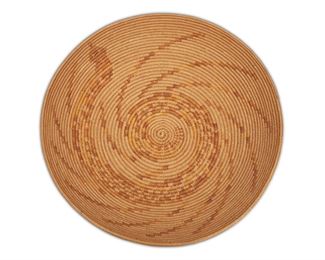121
A Cahuilla Mission Polychrome Snake Motif Basket
First-quarter 20th Century
The deep circular basketry tray decorated with a coiled rattlesnake and radiating bands mimicking the vibrations of the rattle
4" H x 15" Dia.
Estimate: $2,000 - $3,000