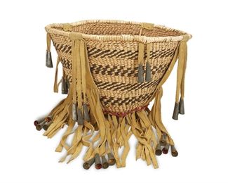 130
An Apache Burden Basket
Third-quarter 20th Century
With hide and metal cones
8" H x 13" Dia.
Estimate: $500 - $700