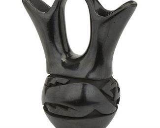 159
A Mida Tafoya Blackware Wedding Pot
(b. 1931, Santa Clara Pueblo)
Signed: Mida Tafoya / Santa Clara Pueblo
The polished blackware wedding pot with incised stepped and geometric design
9" H x 7.5" W x 5" D
Estimate: $300 - $500