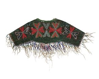 172
A Plateau Beaded Cloth Dress Yoke
Second-quarter 20th Century
Beaded with foliate motif to the front and back, in a polychrome pallet with a variety of beaded tassels
Without fringe: 12" H x 34" W
Estimate: $400 - $600