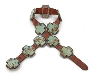 187
A David Reeves Sterling Silver And Turquoise Concho Belt
20th Century; Stamped: D. Reeves / Sterling
Designed with ten cross-shaped turquoise within a sterling stamped framework
Each link: 2.3" L x 2.3" W; Leather length 33"
513 grams
Estimate: $600 - $800
