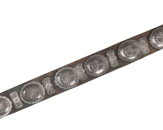 186
A Large Navajo Silver Concho Belt
First-quarter 20th Century
The turquoise-inlaid buckle with six conchos and seven butterflies on a thick leather belt
49.5"L; Each concho: 3.5" H x 4.125" W
1190 grams
Estimate: $1,500 - $2,000