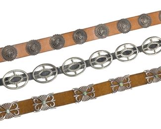 189
Three Southwest Silver Concho Belts
20th Century; Each apparently unsigned
Comprising one sandcast belt set with a single turquoise stone to each concho, one starburst-motif belt, and one belt with round stamped conchos
Belt with oval links each: 3" L x 2.30" H; Longest: 44" L
1150 grams gross
3 pieces
Estimate: $500 - $700