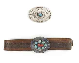 194
Two Navajo Silver Belt Buckles
The larger oval buckle set with turquoise; the buckle with leather belt set with turquoise and coral
Larger buckle: 3.75" L x 2.6" W
264 grams gross
Estimate: $200 - $300