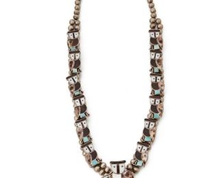 196
A Zuni Owl Mood Squash Blossom Necklace
Signed: B/sun on post/Zuni
The whimsical owl links set with inlaid shell and turquoise
26" L x 2.50" H
188 grams
Estimate: $800 - $1,200