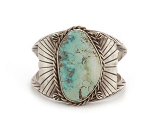 201
A Glen Adakai Navajo Slab Turquoise Cuff Bracelet
Stamped G.A. for Glen Adakai
Designed with rope wire and split wire and centering on a large turquoise tablet
7" L x 2.1" H
82 grams
Estimate: $300 - $500
