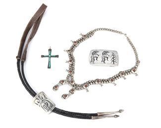 208
A Group Of Hopi And Zuni Silver Jewelry
Mid-20th Century
Bolo stamped for Gene Pooyouma, Hopi; Buckle stamped for Joseph Harlan / Sterling; Cross marked: L. Iule [Lupe lule]
Comprising a Hopi bollo tie with silver overlay Kokopelli motif to fitting and finished with silver tips by Gene Pooyouma, a Hopi Kokopelli themed silver belt buckle by Joseph Harlan, a Zuni turquoise-set cross pendant by Lupe Iule, and a squash blossom necklace strung with a double row of silvr beads supporting ten coral shadowbox set stones on bear paw blossoms and finished with a five paw naja, 4 pieces
Squash blossom: 22" L; Belt buckle: 2" H x 3" W
Estimate: $500 - $700