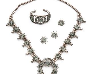 205
A Set Of Daniel And Christine Eriacho Zuni Petite Point Jewelry
Signed
Comprising a squash blossom necklace, a cuff bracelet, a pair of earrings, and a ring
23" L x 2.5" H
161 grams
5 pieces
Estimate: $1,000 - $1,500