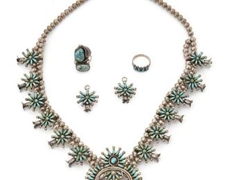207
A Set Of Zuni Turquoise Petite Point Jewelry
Unmarked
Comprising a squash blossom necklace, a pair of earrings, and two rings set with turquoise
Necklace: 22" L x 2.1" H
137 grams
5 pieces
Estimate: $800 - $1,200