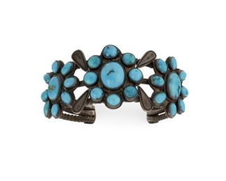 206
An Early Zuni Cluster-Style Bracelet
First-quarter 20th Century
Designed with three turquoise-set medallions soldered to three twisted wires
6.5" C x 1.25" H, wrist opening: 1.25"
67.5 grams
Estimate: $500 - $800