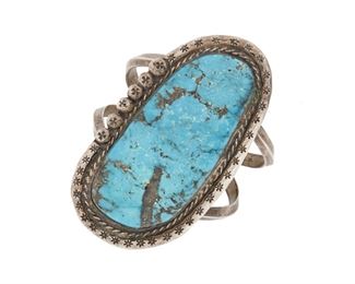 211
A Large Southwest Turquoise Cuff Bracelet
Mid-20th Century
A large turquoise slab cuff bracelet with rope work and stamping to edges mounted to a two-wire cuff
6.5" L x 3.25" H x 1.6" W
84.7 grams
Estimate: $400 - $600