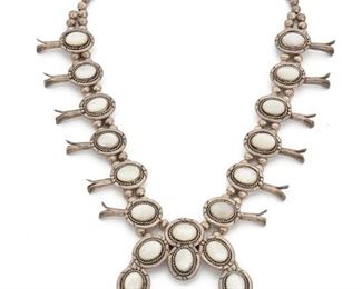 214
A Large Silver And Mother-Of-Pearl Squash Blossom Necklace
Designed with bezel-set mother-of-pearl elements
25"L x 3.25" H x 3.75" W
292 grams
Estimate: $300 - $500