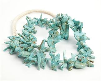 219
A Navajo Turquoise Fetish Necklace
Mid-20th Century or later
A single strand of turquoise carved animals including bears, rabbits, fish, turtles, fox, and others with a larger standing bear to center
32" L x 2" H
Estimate: $200 - $400