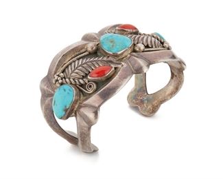 225
A Sadie Calvin Navajo Cuff Bracelet
Stamped with maker's cypher
A heavy cuff set with turquoise and coral with a feather motif
6.75" L x 1.50" H
100 grams
Estimate: $300 - $500