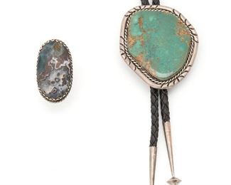 231
Two Silver Southwest Jewelry Items
Comprising a bolo tie embellished by a large tuquoise slab and a large turquoise ring, 2 pieces
Bolo: 3" L x 2.5" W
153.9 grams gross
Estimate: $400 - $600