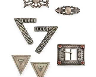 234
A Group Of Southwest Jewelry Items
Mid-20th Century; Brooch stamped: Coin silver
Comprising a sandcast brooch, a pair of stamped collar tips, a pair of pictorial stamped collar tips, a rectangular buckle with coral corners and ropework, and a silver brooch with button design
Largest: 2" H x 2.5" W
115.5 grams
7 pieces
Estimate: $400 - $600