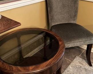 One of two round side tables; one of the dining chairs