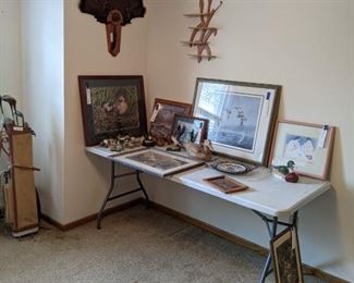 Upstairs bedroom featuring framed prints, duck items, and turkey tail mount.