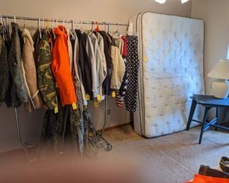 Queen size pillow top mattress $20 (clean), table with rotating top, and an assortment of clothing including hunting jackets.  Most are size XL and XXL