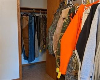 More stuff in closet including pants and t-shirts.