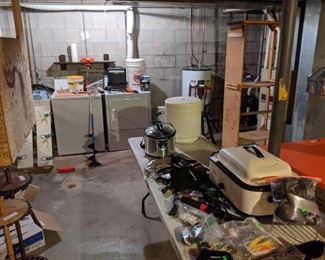 More items in basement, fishing rod racks, Ice fishing equipment, fish finder, high chair, crock pot, Nesco, dehydrator, and more hunting gear.  