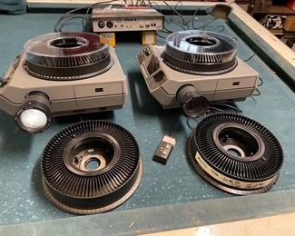 2 Kodak 111 b slide projectors w/ tamron zoom lens 70-125mm focal length. Both have “hotshot” module modification to increase brightness. EXW bulbs. Comes with 4 trays and 2 spare lamps! 