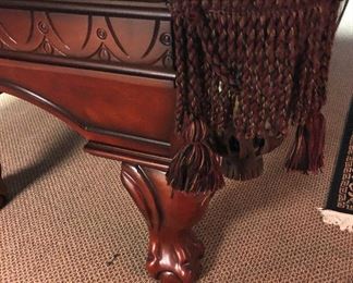 Carved legs and border; fringed pockets