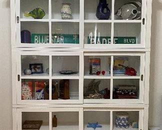 Crate and barrel stocking library shelves with glass fronts.