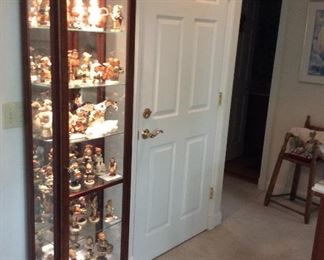 A tall lighted curio cabinet