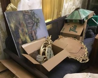 Cane back Sofa, stained glass chandelier, painting