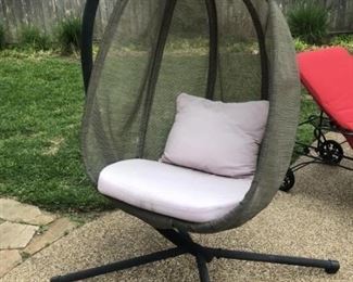 Mesh and Metal Outdoor Swing Chair hanging from sturdy metal frame