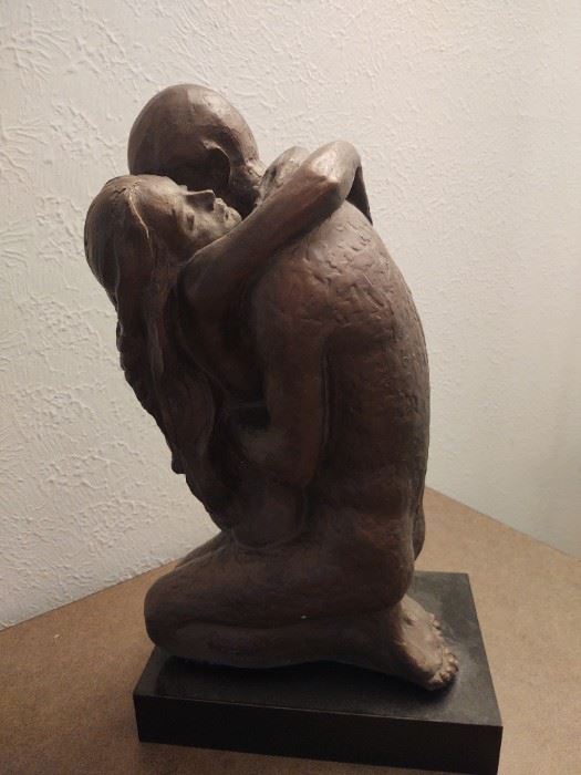Dark ceramic sculpture of man and woman in embrace, 70s-80s