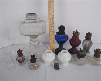8 oil lamps missing their chimneys, 3 chimneys and 2 bases