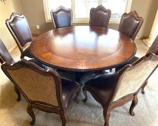 Simply Stunning Round Dining Room Table w/ Eight Chairs. Imagine all the wonderful gatherings and dining experiences this beautiful table can offer! It is truly a beautiful table!
The table measures 75" in diameter and 31" H.
The chairs offer generous seating room boasting seat dimensions of 19" x 23" and are 46" h
