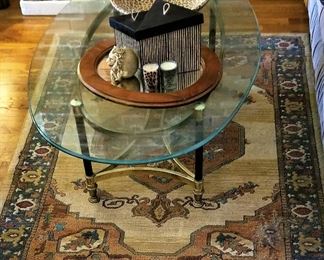 Oval glass coffee table and southwest Aztec rug.