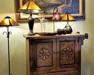 Fabulous wooden sideboard with wooden bar at the right side.  Lots of table lamps.
