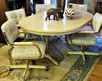 Light wood oval dining table and chairs.