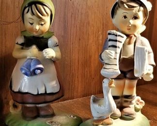 Collectible boy and girl Hummel ceramics.