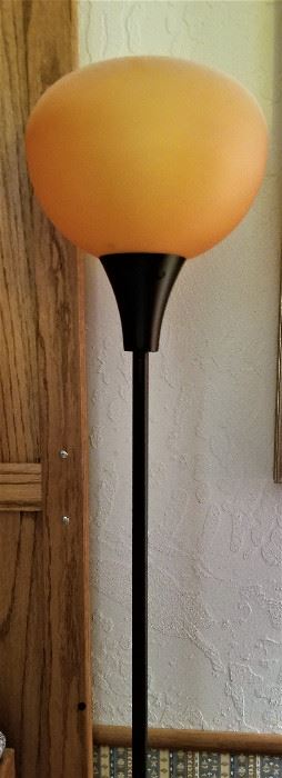 Glass globe floor lamp without the light on. Pretty color.