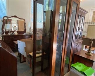 Pair of lighted curio cabinets with glass shelves 