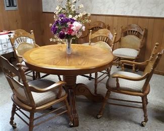 Pedestal table with leaf and six chairs on wheels. Also, think game table