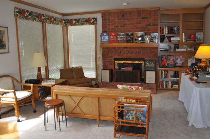 Tomlinson MCM upholstered sofa (72” long x 28.5/16” high x 33” deep) and matching chair (31” wide x 28.5/16” high x 32” deep), both with crisscross wooden back, Tomlinson Sophisticate MCM cocktail/bar/storage table 1950s (33” square x 23” high), Ampex vintage 985a music center amp, tuner, reel to reel with Ampex 830 speakers and recorder accessory kit, MCM teak plywood set of four round stools w/three metal legs (13” diameter x 18” tall), 
rattan vintage magazine rack from Gump’s
