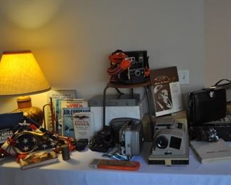 U.S. flags, lamp, books, cameras, projectors, Bolex 18-5 Super vintage projector, Bolta Photavit vintage camera in leather case, ERNIE! 