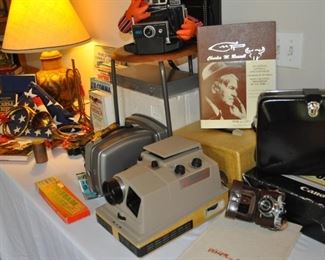 U.S. flags, lamp, books, cameras, projectors, Bolex 18-5 Super vintage projector, Bolta Photavit vintage camera in leather case, ERNIE! 
