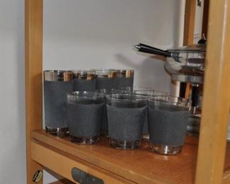 Dolphin MCM Danish Modern folding teak tea cart, MCM barware and tools, MCM chafing dish/buffet server Spain, Stelton MCM Denmark stainless steel round tray w/bowl, Dansk wooden tongs, Gump’s “Bullit” MCM glass barware Italy
