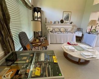 Ethan Allen upholstered pair of chairs (25.5” wide x 42.5/19” high x 27” deep), Henredon Travertine vintage dodecagon coffee table round base w/wheels and six columns (50” across x 16” high), display cabinet lighted tall w/mirrored back and glass shelves (89” tall x 22” wide x 12” deep), sterling, crystal, silver plate, art, vintage linens, Lladro
 