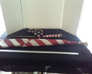 3 American Flags 1 is plastic and one is on a 58 inch tall pole