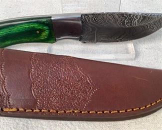 Mfg - Custom Hand Made
Model - Damascus Steel Knife
Caliber - 3.5" Blade
Located in Chattanooga, TN
This lot contains a Custom hand made Damascus steel knife. This knife has a 3.5" blade with an emerald green stained wooden handle, overall length of 8". Full tang design with custom leather embossed sheath.
